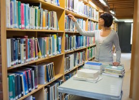 Library worker shelving books. 